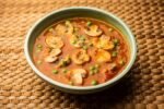 Mushroom and Pea Curry with Roasted Garlic, Indian food served in a bowl